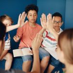 Group of diverse kids collaborating and learning together in a classroom setting.