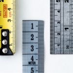 High-resolution image of a tape measure and rulers, showing precise millimeter, centimeter, and inch markings.