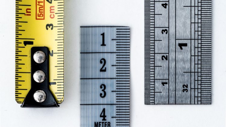 High-resolution image of a tape measure and rulers, showing precise millimeter, centimeter, and inch markings.