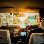 Experience a scenic ride through Kyoto in a traditional taxi, capturing urban life during sunset.