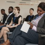 Business professionals engaged in a seminar, taking notes and listening attentively.