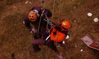 Rope access professionals engaging in technical rescue training during a daring outdoor adventure.