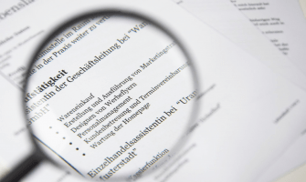 Close-up of a business document text under a magnifying glass.