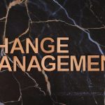 Wooden letters spelling 'Change Management' on a dark marble surface, emphasizing business change.
