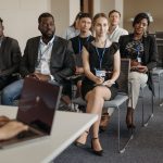 Diverse group of business professionals attentively attending a conference session.