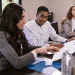 Diverse colleagues engaged in a business discussion at a conference table.