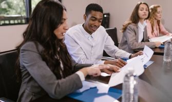 Diverse colleagues engaged in a business discussion at a conference table.