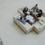 Aerial view of a group business meeting in a modern office setting.