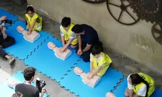 A CPR workshop in Baku, Azerbaijan featuring participants practicing on mannequins with guidance from an instructor.