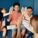 Group of diverse kids collaborating and learning together in a classroom setting.
