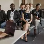 Diverse group of business professionals attentively attending a conference session.