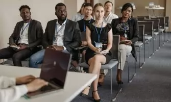 Diverse group of business professionals attentively attending a conference session.