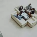 Aerial view of a group business meeting in a modern office setting.