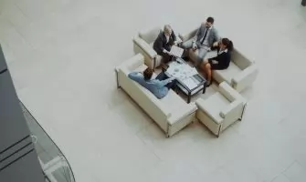 Aerial view of a group business meeting in a modern office setting.